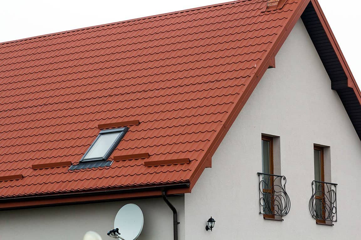 Redlands roof with red tile roofing and skylight window.