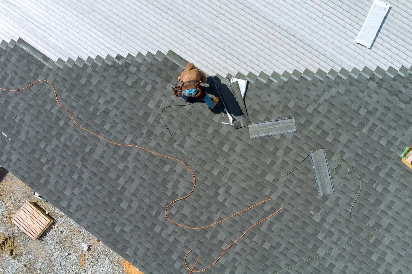 Roofing contractor installing shingles on a roof in Redlands, CA.