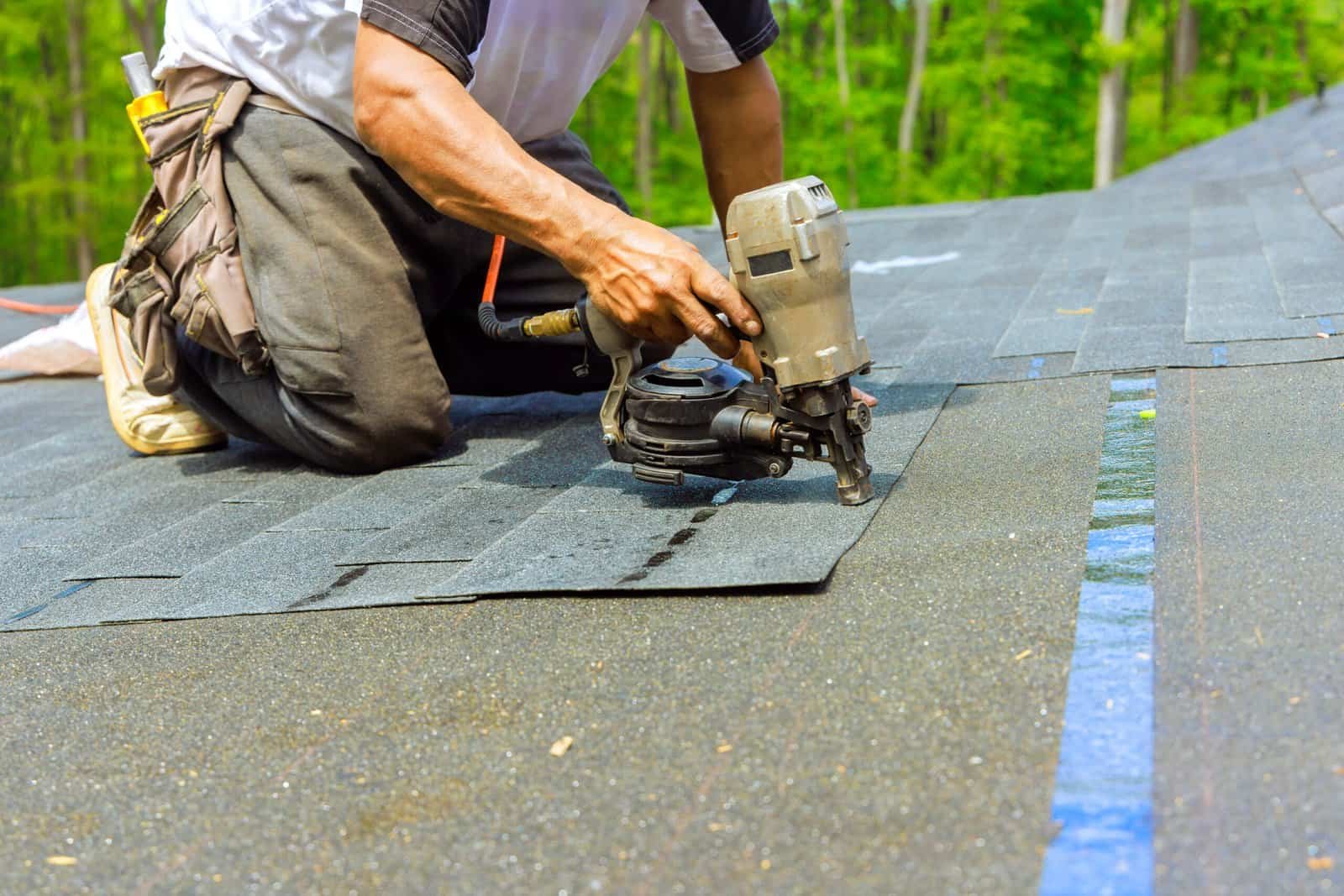 Roofing contractor installing shingles on a roof in Redlands, CA.